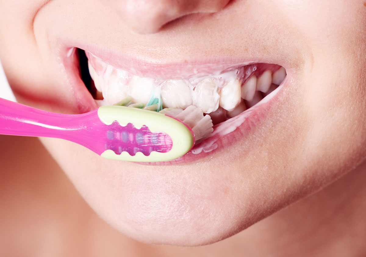 Woman brushing her teeth - Dentist in West Chester PA