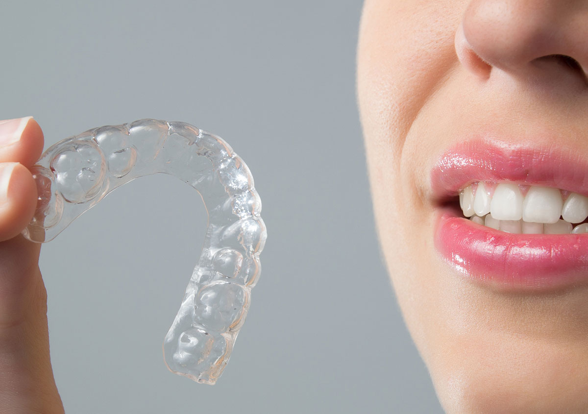 Woman holding mouth guard - Dentist in West Chester PA