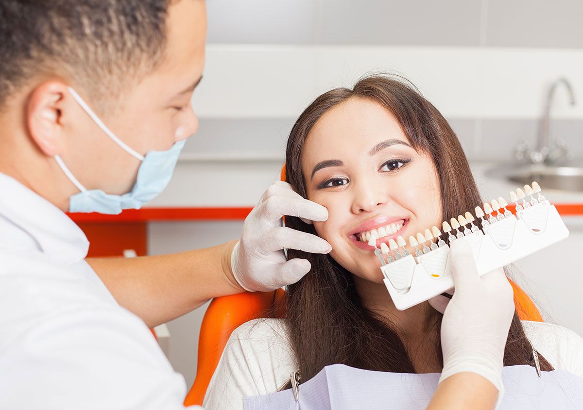 Dentist comparing porcelain crowns - Dentist in West Chester PA