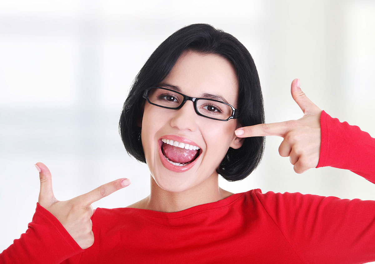 Woman pointing finger at her teeth - Dentist in West Chester PA