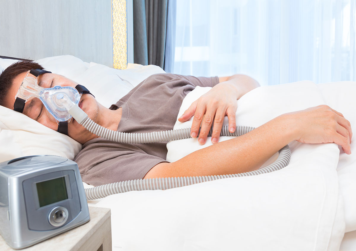 Man sleeping with CPAP on