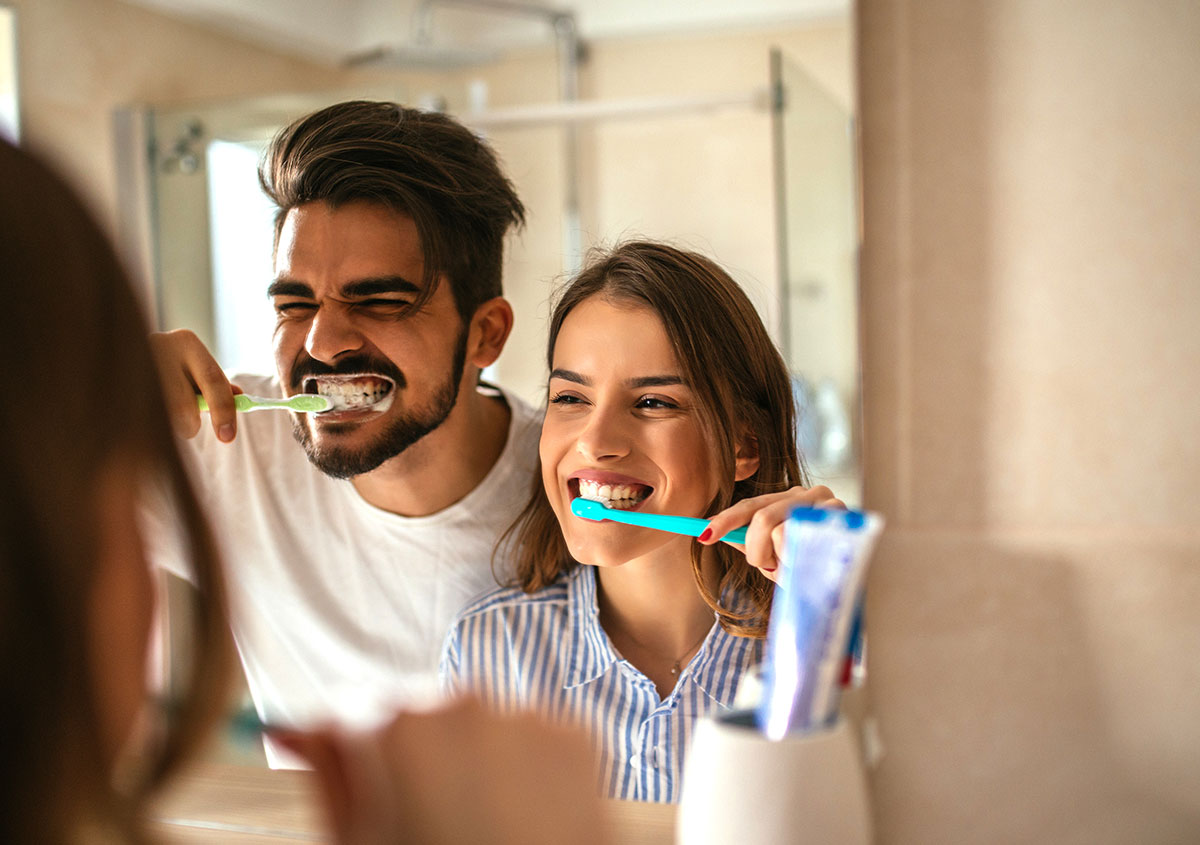 Couple brushing teeth