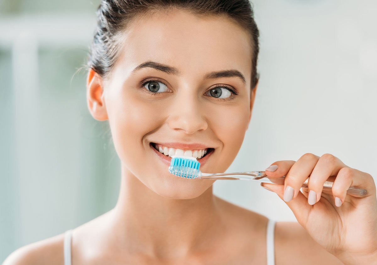 Woman brushing her teeth - Dentist in West Chester PA