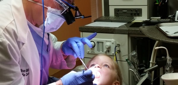 Dr Ron performing dental surgery