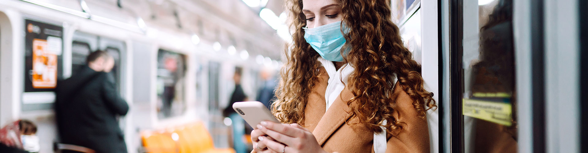 Woman wearing mask while traveling in the train